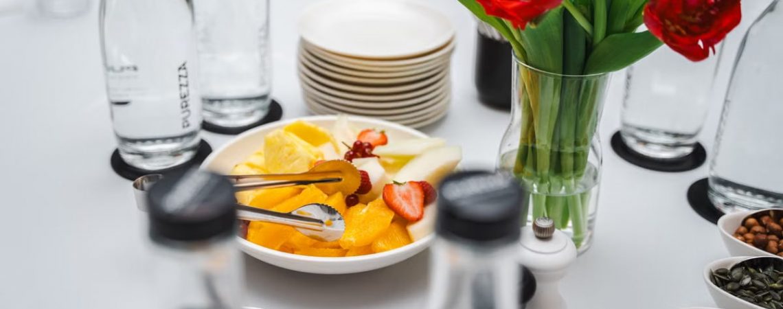 An elegant dining setup featuring fresh fruits and vibrant tulips, perfect for a healthy meal.