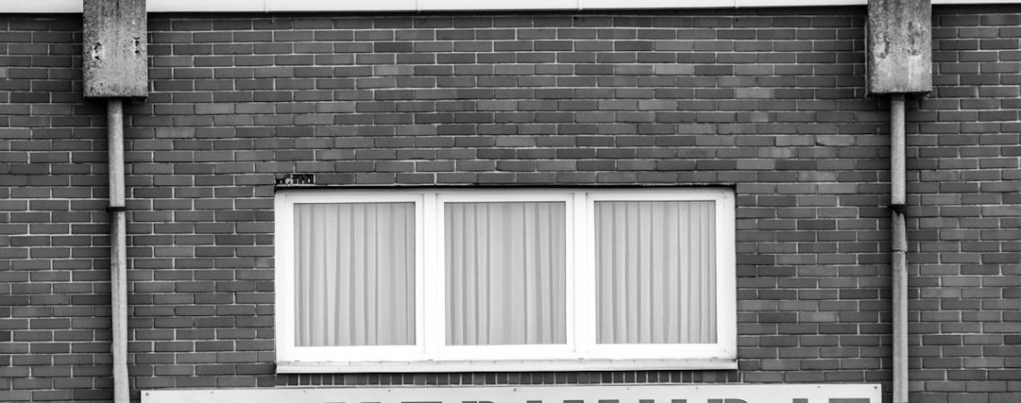 A black and white photo of a brick building